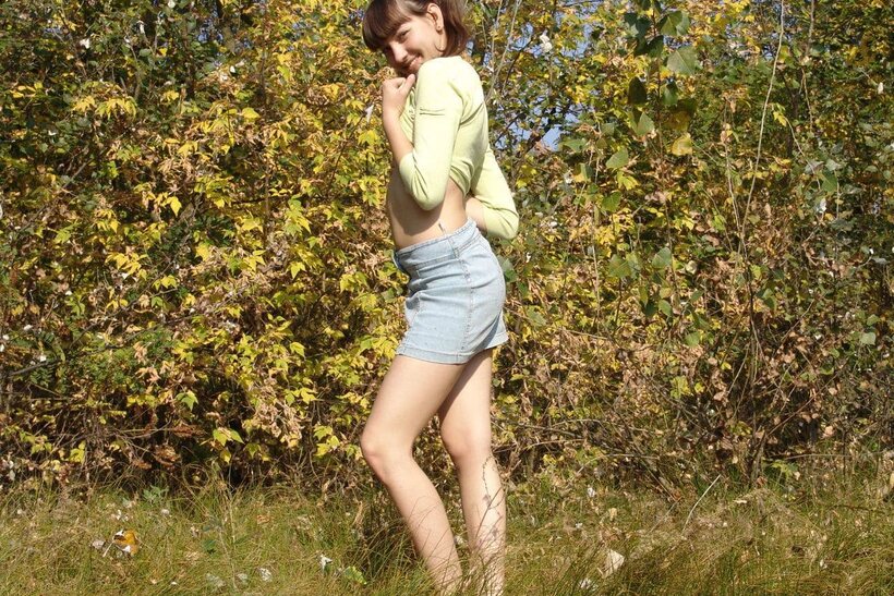 Amateur nude photo 7 — Outdoors, a playful teen undresses fully and shows her bare pussy close-up