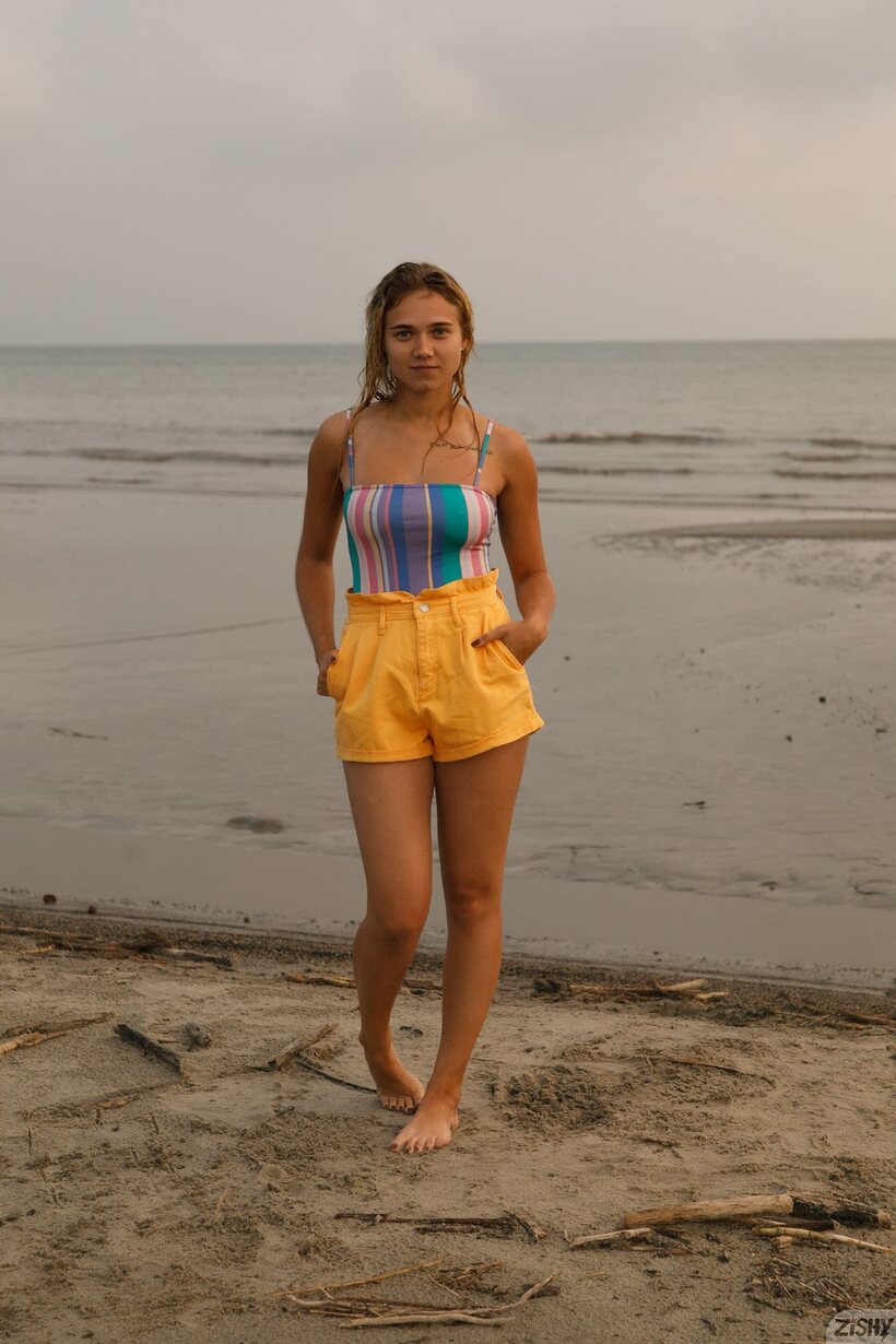 Photo 7 — Rebel Tee flashes her sexy swimsuit curves in a beachside pose
