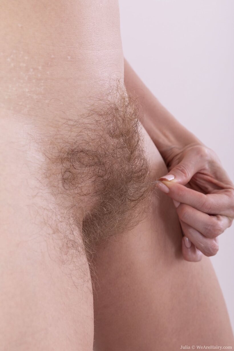 Photo 18 — Naked blonde MILF Julia fingers her thick hairy pussy with eager hands