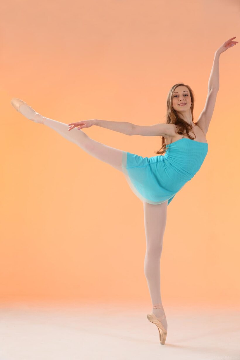 A flexible redhead strips her ballerina outfit and poses nude in pantyhose, photo 2 of 21