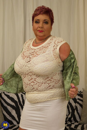 Mature redhead reveals her big naturals before getting herself off