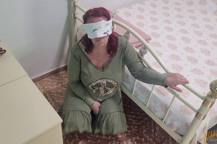 Nikki Holland blindfolds herself while toying with her panties in a dress, photo 1 of 15