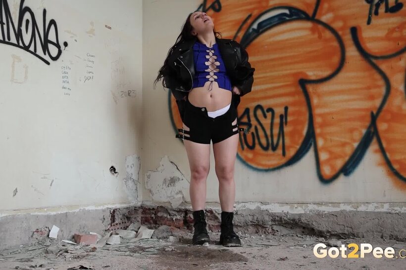 Squatting to piss, a brunette BBW uses an abandoned building, photo 14 of 15