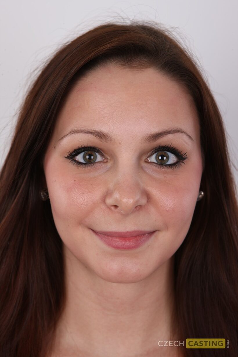 Clothed brunette amateur slowly strips down after a casting session (shot 1)