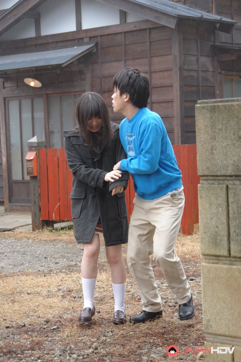 Mai Shimizu kneels outside and blows a guy while handworking him (shot 1)