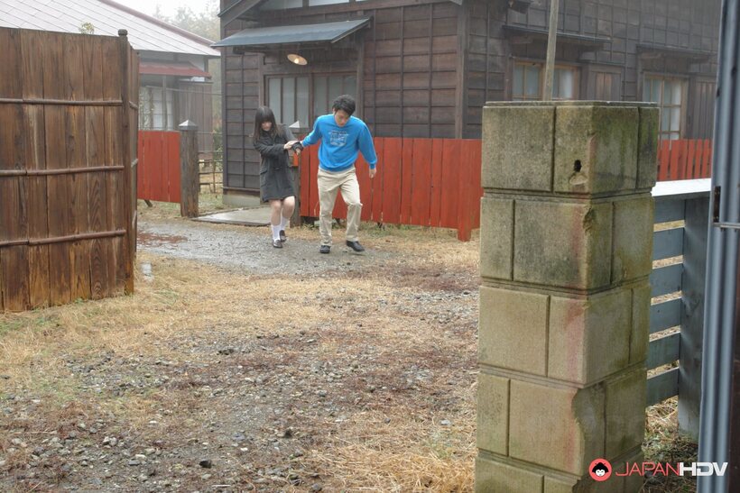 Mai Shimizu kneels outside and blows a guy while handworking him (shot 2)