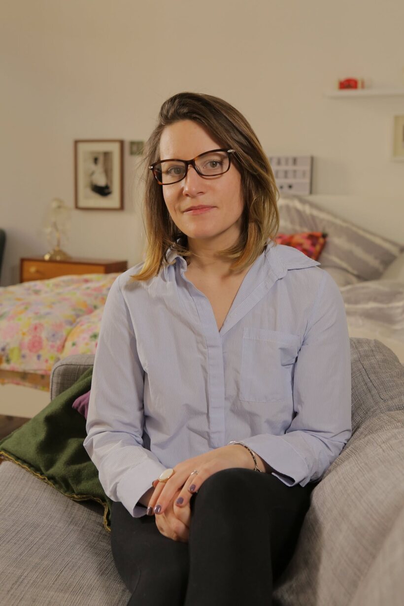 German amateur sits naked cross-legged on the bed, then dresses (shot 18)