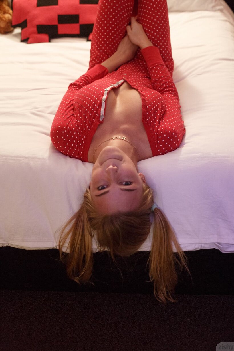 Image 7/11: Kendra Sunderland flashes her big tits in a Christmas bedroom scene