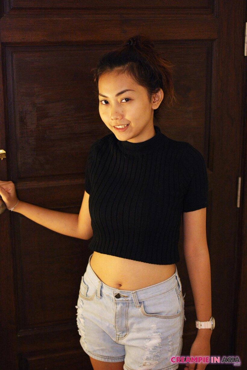 Petite girl flaunts her small tits while teasing, photo 2 of 16