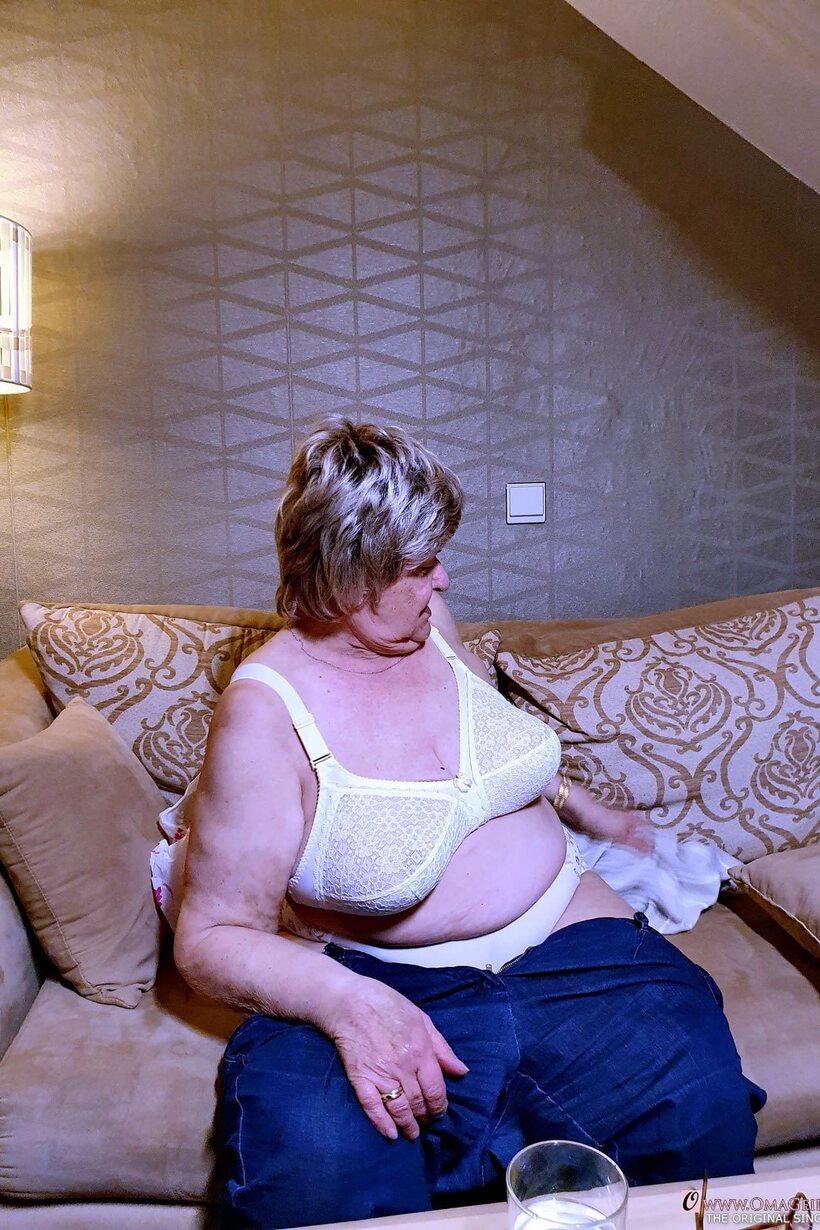 Amateur nude photo 4 — Melba teases her saggy tits while slipping out of her clothes