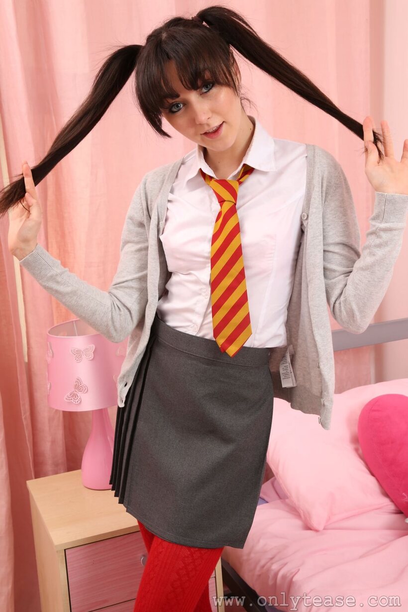 Pigtailed Millie P poses with her bubble butt on display in a skirt (shot 1)