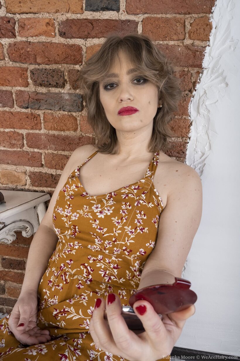 Yulenka Moore slips out of her dress and exposes her hairy cunt (shot 1)