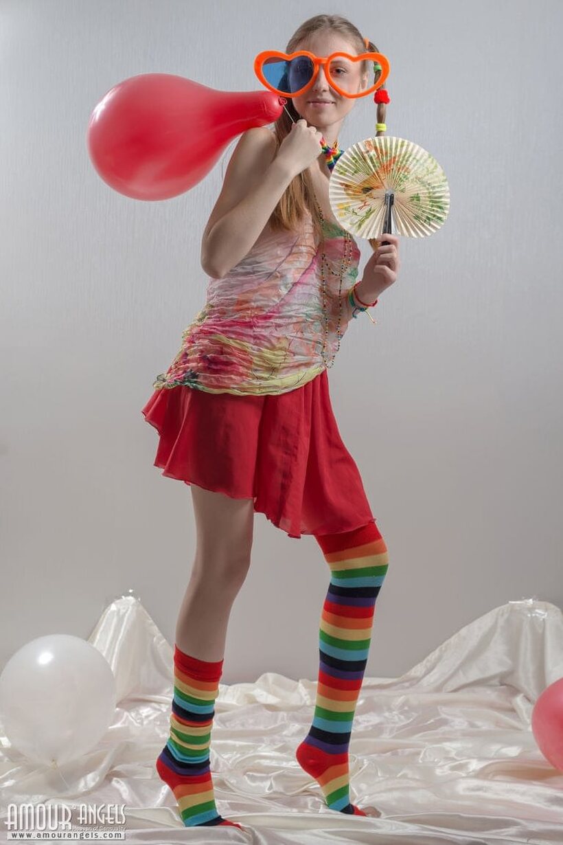 Pigtail teen in colorful socks strips off her clothes, photo 1 of 20
