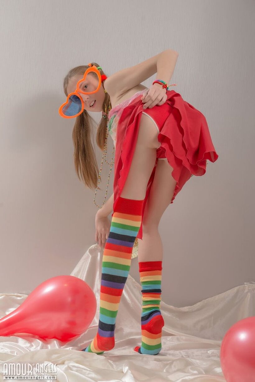 Pigtail teen in colorful socks strips off her clothes, photo 3 of 20