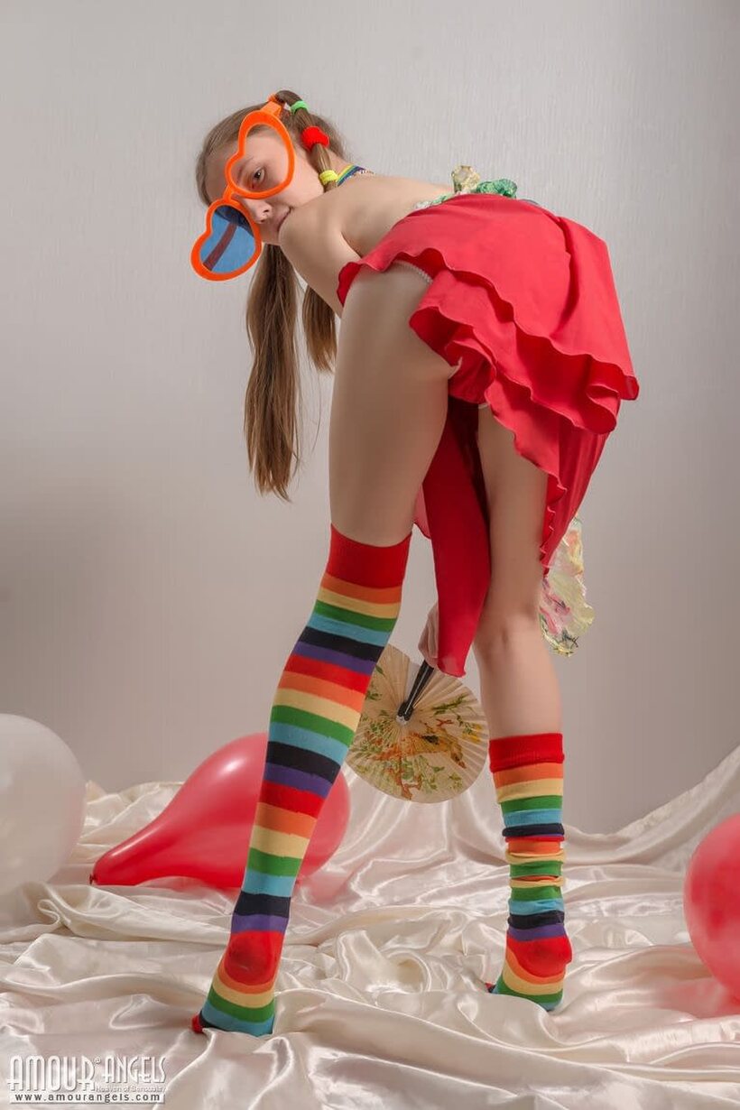 Photo 4 — Pigtail teen in colorful socks strips off her clothes