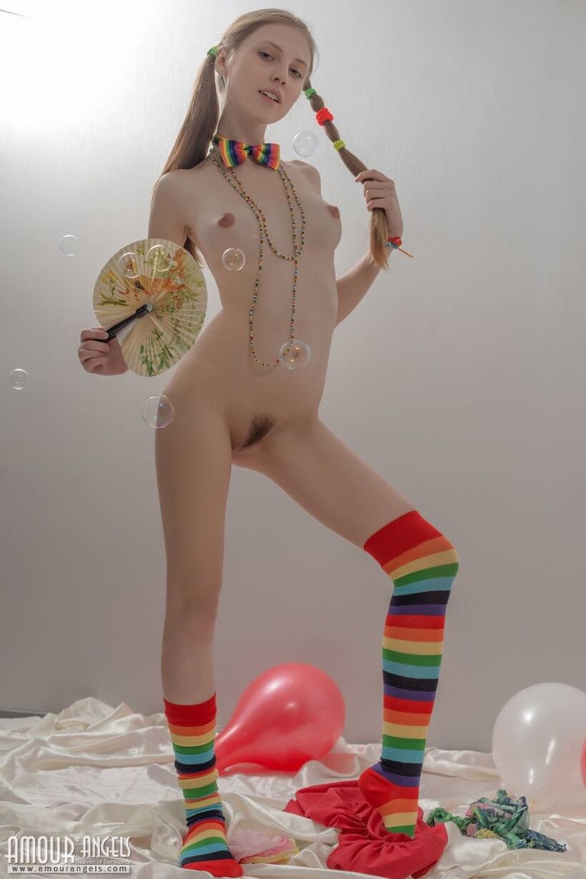 Pigtail teen in colorful socks strips off her clothes, photo 16 of 20