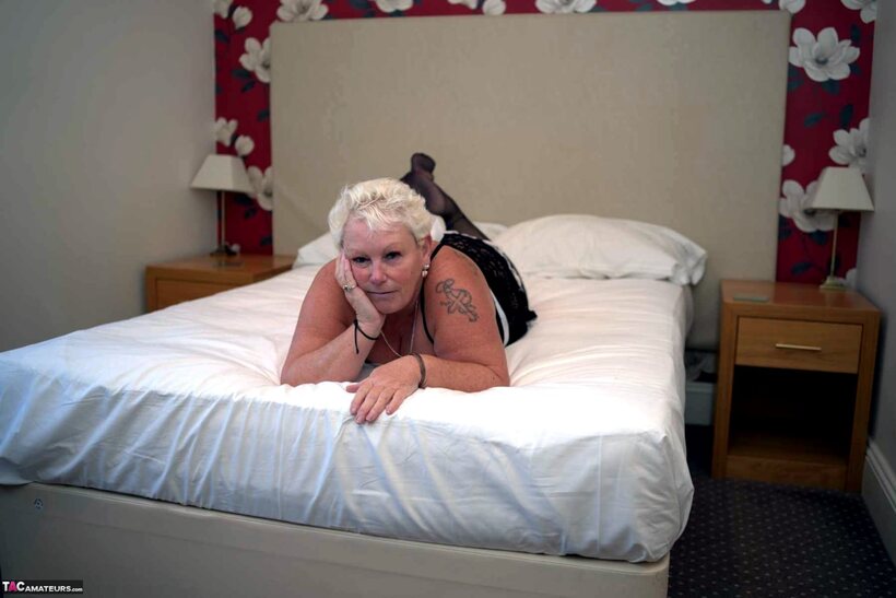 Maid reveals no panties in bed during a blonde upskirt tease, photo 4 of 16