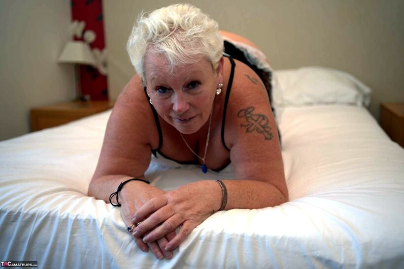 Image 6/16: Maid reveals no panties in bed during a blonde upskirt tease