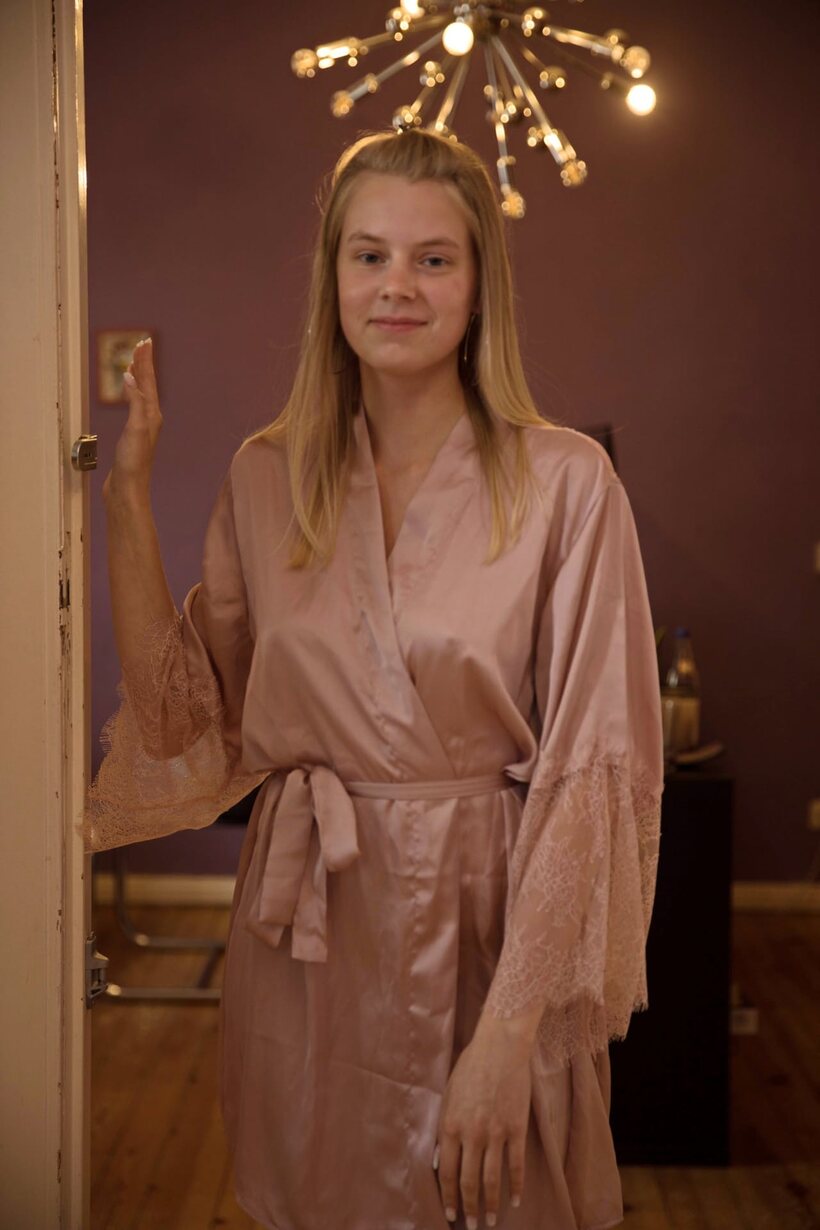 Beautiful girl gets naked in bed (shot 1)