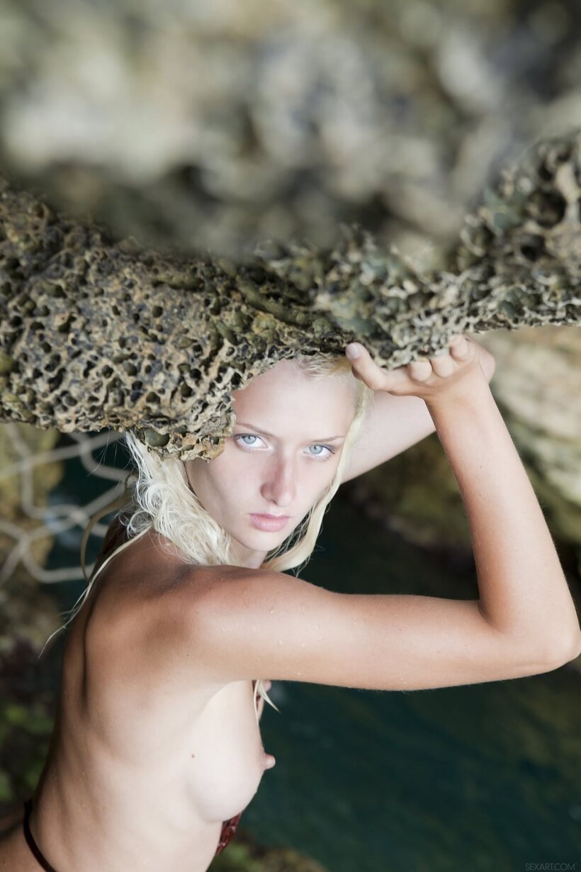 Image 5/21: Nika N rises from the water and poses nude as a platinum blonde teen
