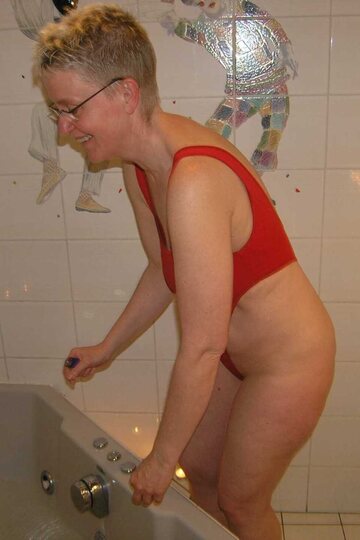 Blonde Tiffany Pearl up close: wet pussy and legs in a micro bikini