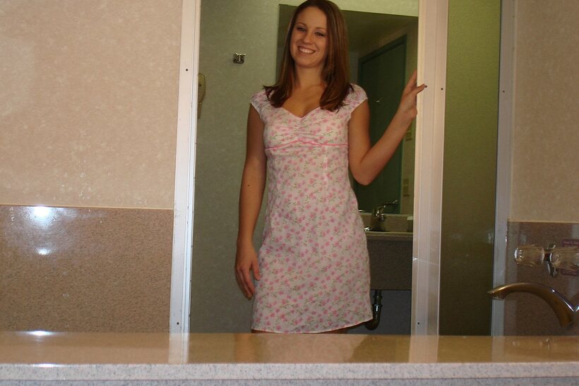Brie slips out of her dress and shows off her natural tits and ass, photo 1 of 21