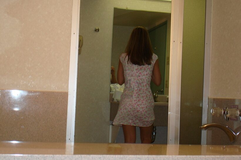 Brie slips out of her dress and shows off her natural tits and ass, photo 2 of 21