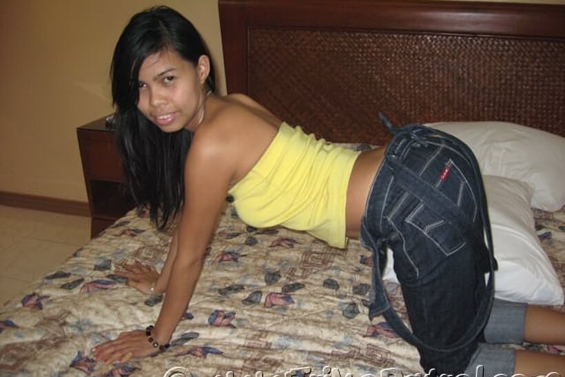 Image 5/20: On the bed, an Asian amateur goes fully nude in her bedroom