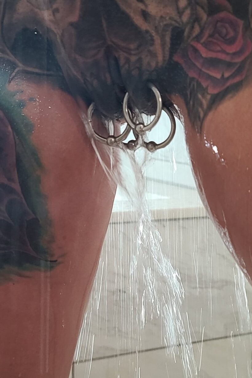 Tattooed Marie Bossette poses with her small fake tits on display in the shower (shot 9)