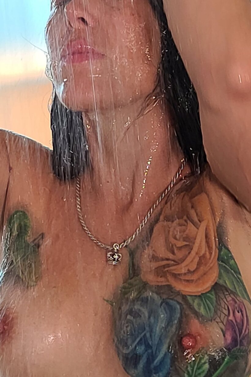 Photo 15 — Tattooed Marie Bossette poses with her small fake tits on display in the shower