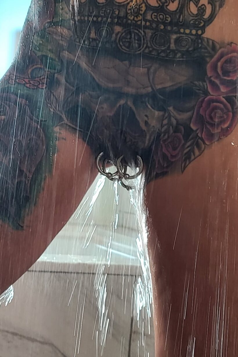 Tattooed Marie Bossette poses with her small fake tits on display in the shower (shot 16)