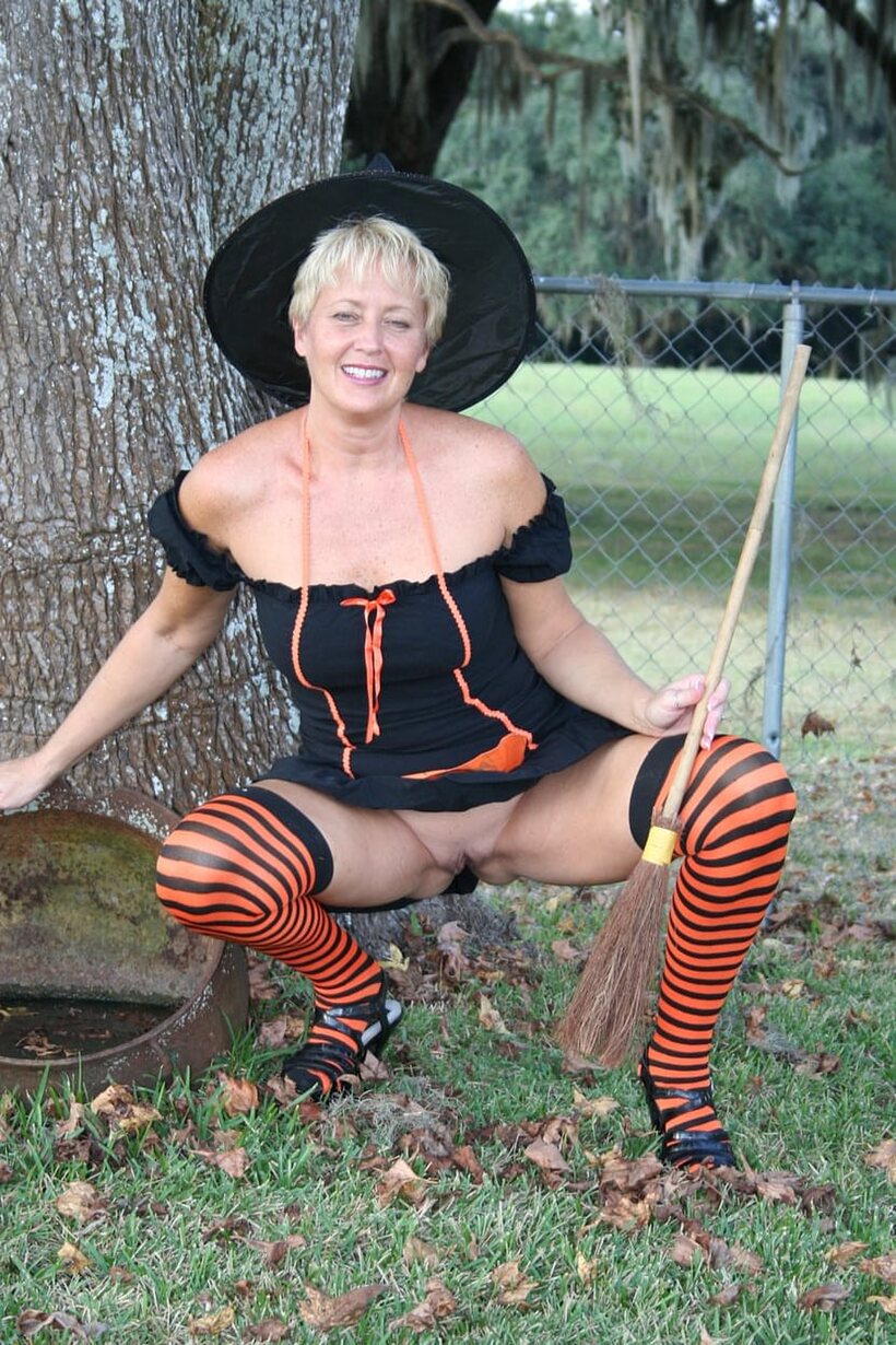 Outdoors in a Halloween costume, Tracy Lick teases her ass with a broom, photo 5 of 20