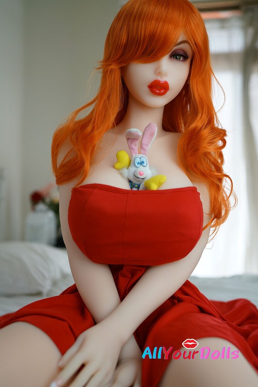 Sex Doll nude photo 3 — Redhead on the bed plays with a bunny between her huge tits