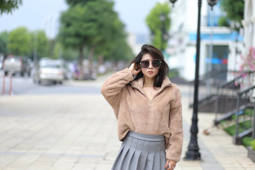Sexy girl in glasses shows her legs outdoors, photo 12 of 21
