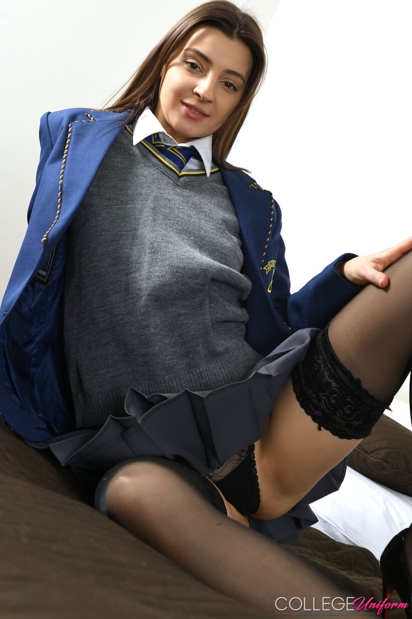 Photo 4 — Melena Maria lifts her school uniform and flashes her shaved pussy and ass