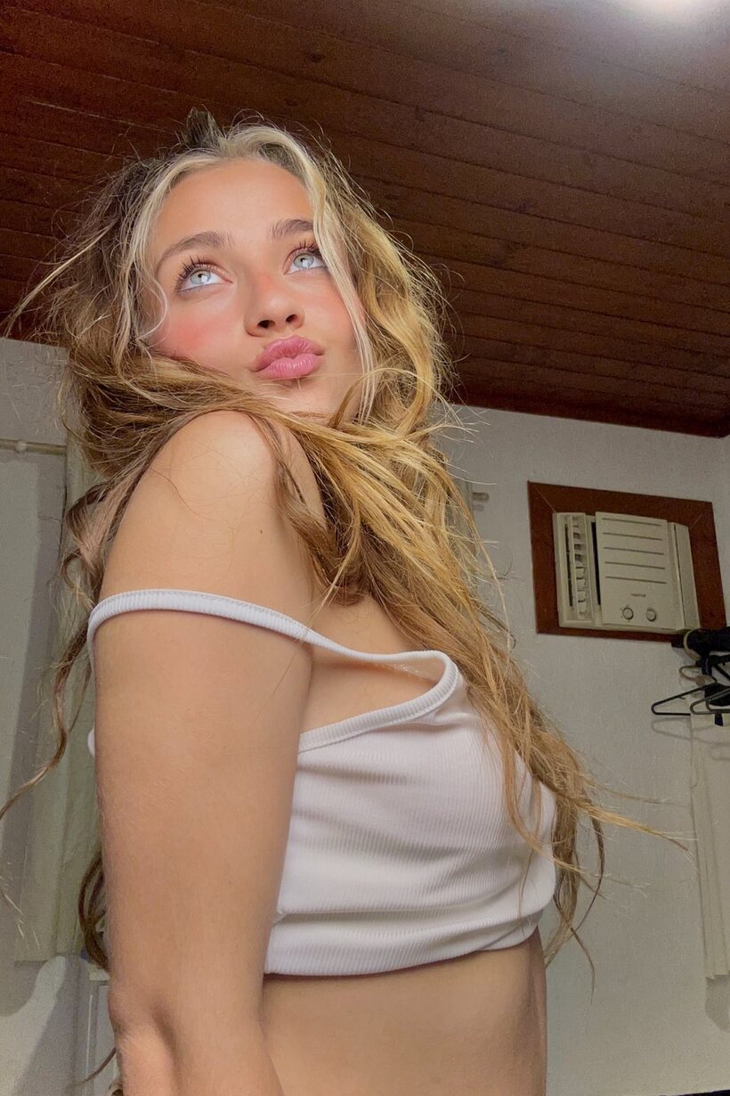 Blonde girl poses with her natural tits on display (shot 10)