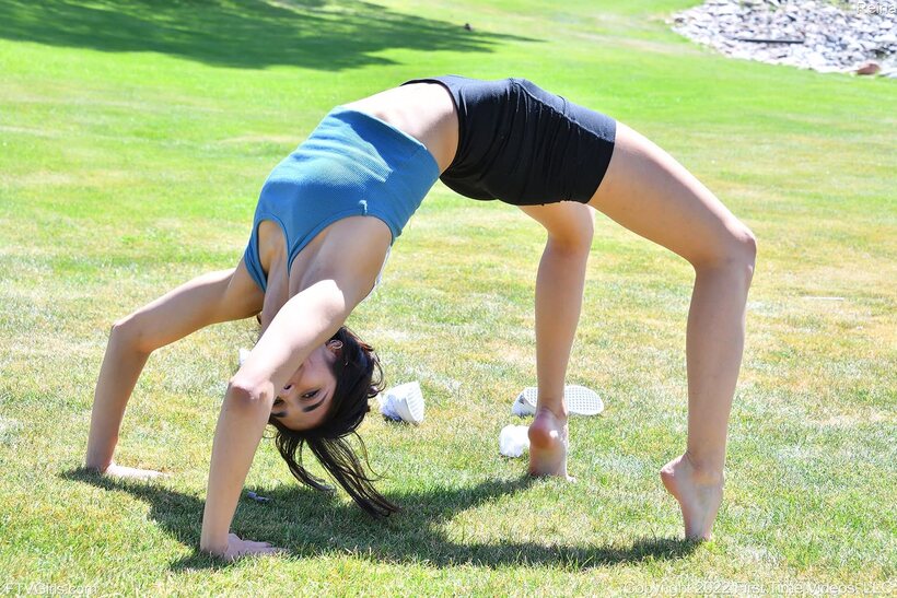 Going naked outside, Reina Rae stretches out in shorts before exercising, photo 5 of 15