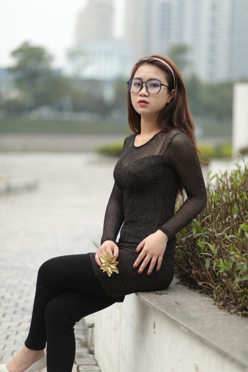 Asian babe in glasses shows off her tight outfit outdoors (shot 9)