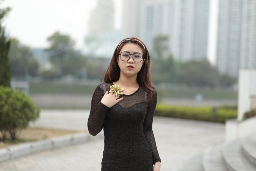 Photo 14 — Asian babe in glasses shows off her tight outfit outdoors