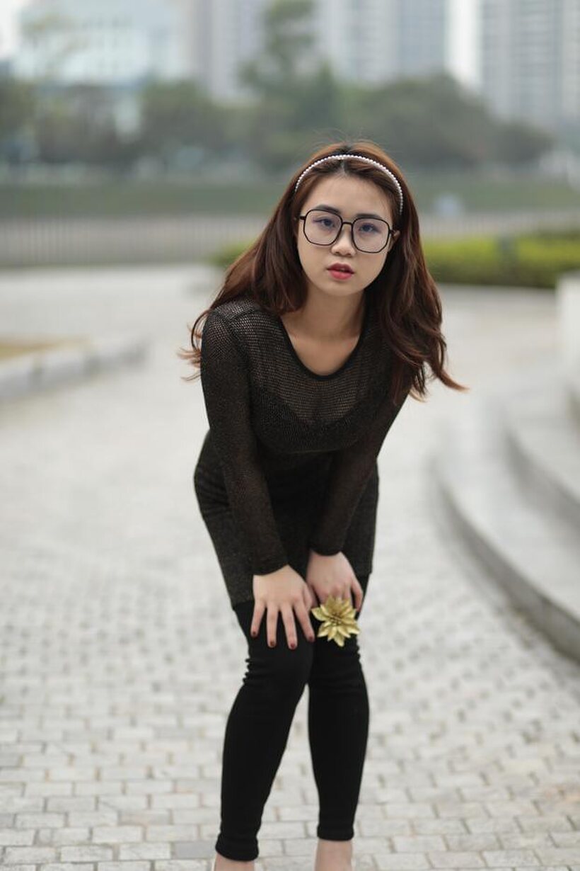 Photo 17 — Asian babe in glasses shows off her tight outfit outdoors