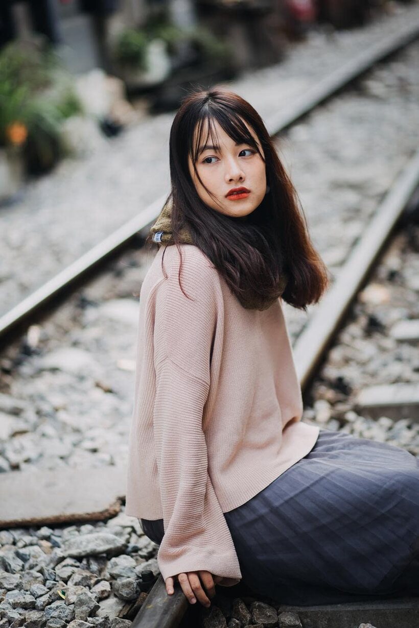 Image 8/21: Posing on the railroad, this gorgeous Asian model shows off her outfit