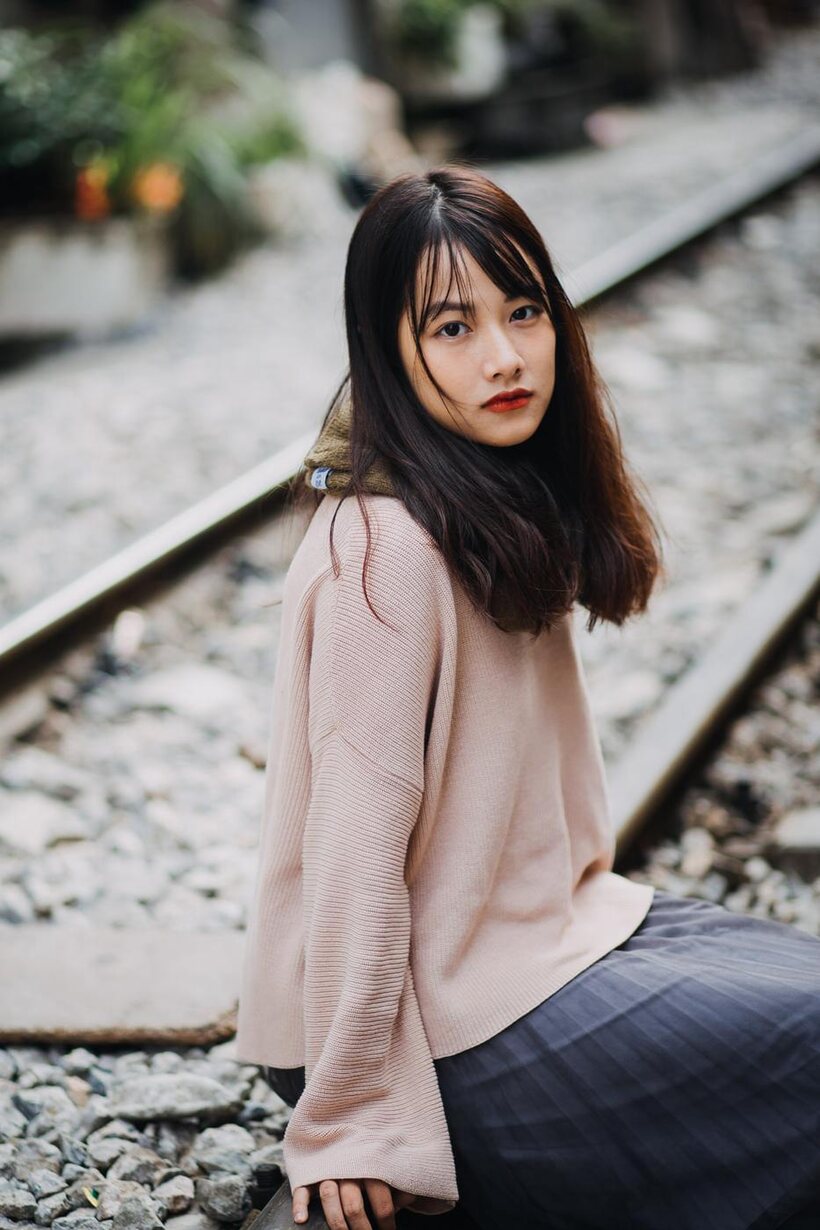 Image 9/21: Posing on the railroad, this gorgeous Asian model shows off her outfit