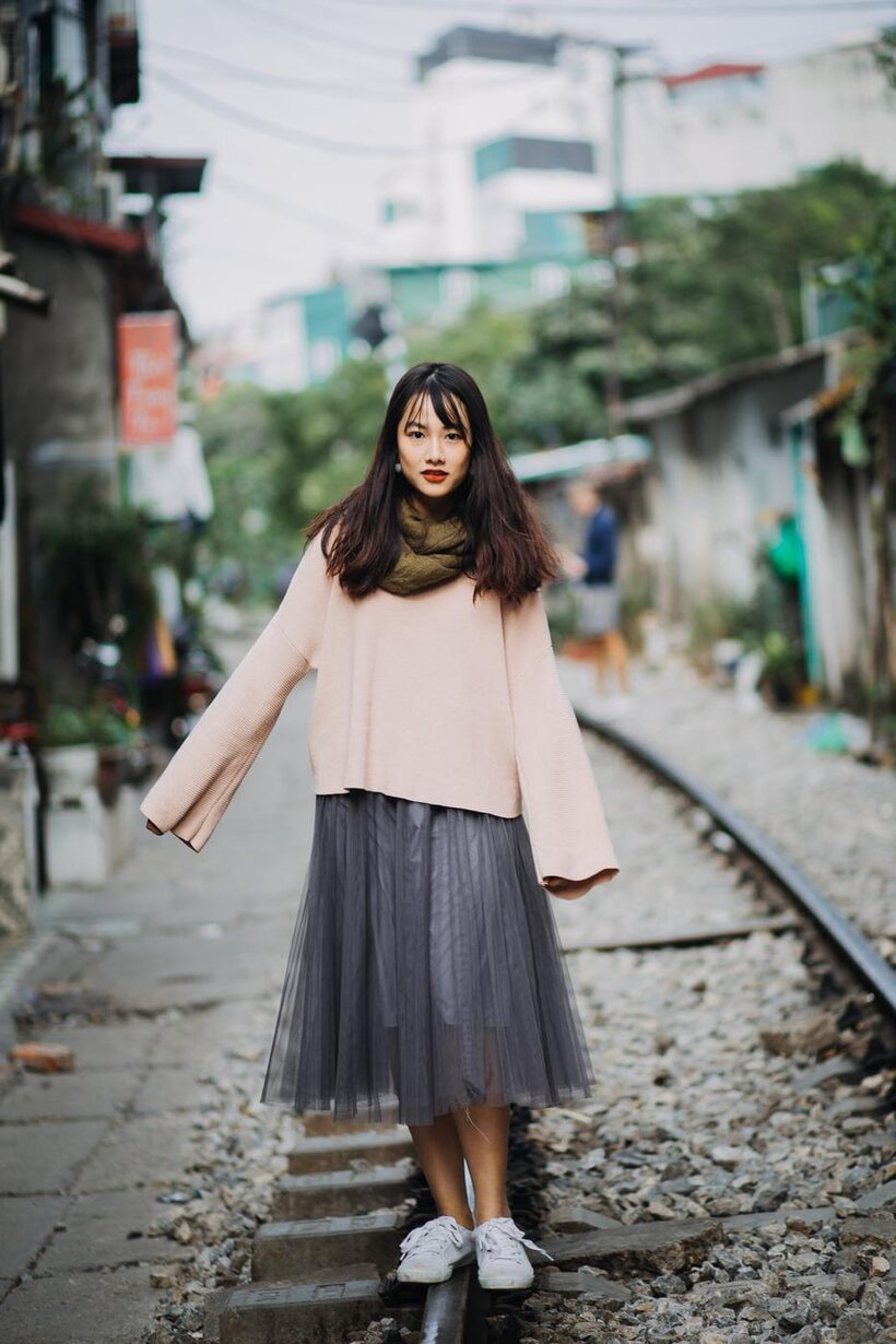 Posing on the railroad, this gorgeous Asian model shows off her outfit (shot 11)