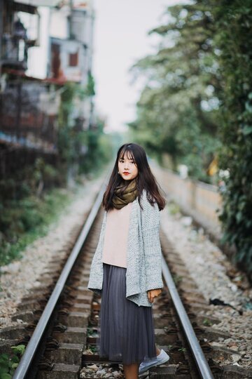 Posing on the railroad, this gorgeous Asian model shows off her outfit