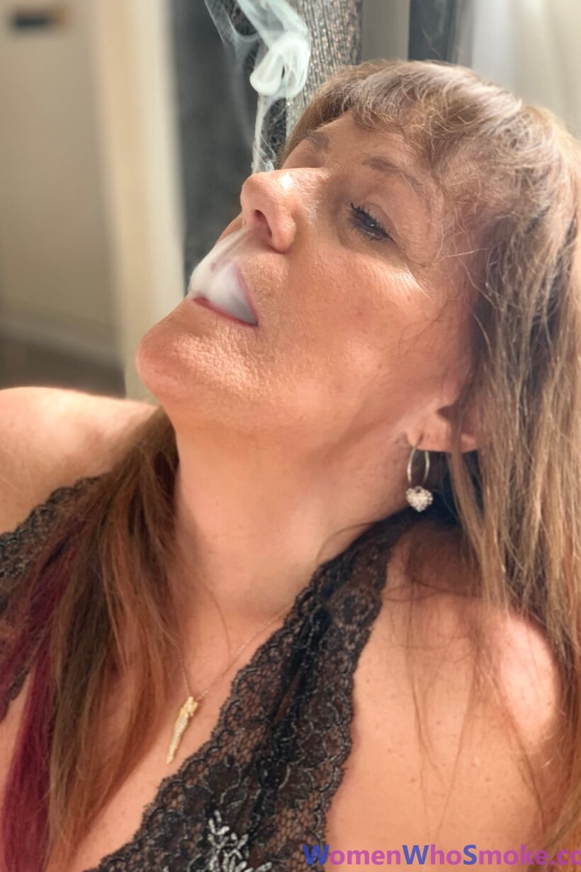 Pandora Smith smokes a cigarette and poses in lingerie, photo 14 of 15