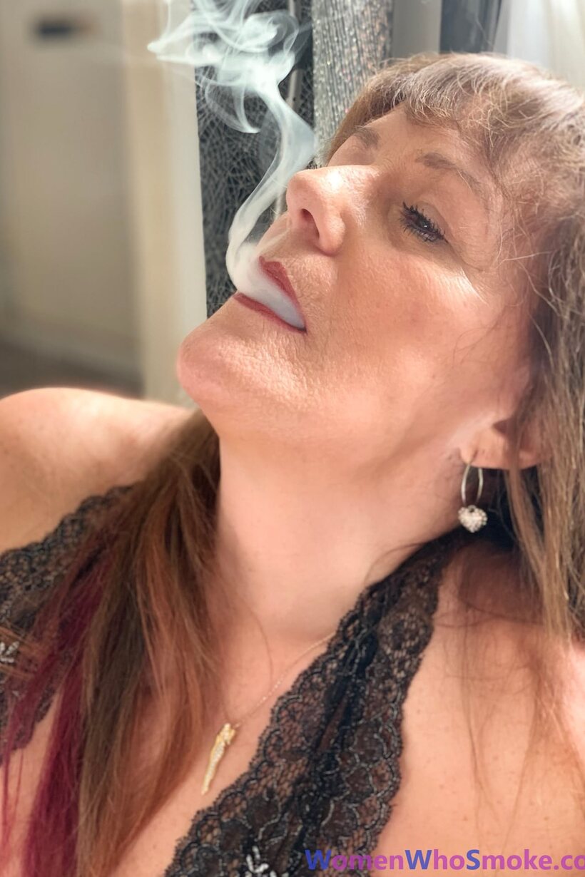 Image 15/15: Pandora Smith smokes a cigarette and poses in lingerie