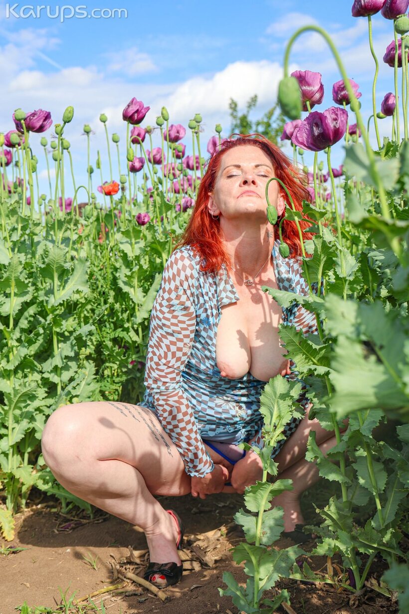 Photo 1 — Sucking and fucking in a field, redheaded amateur shows off big natural tits
