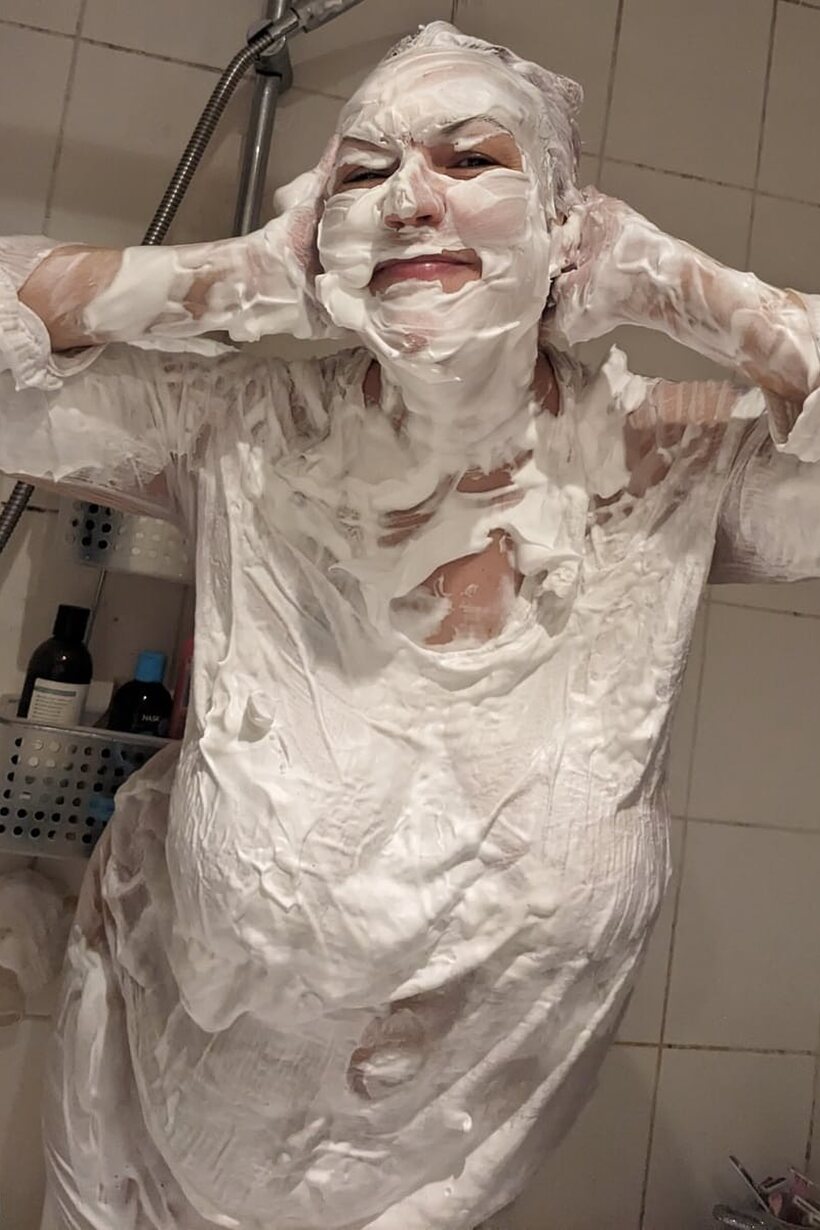 Image 12/16: Layla Bird coats herself in shaving cream in the shower