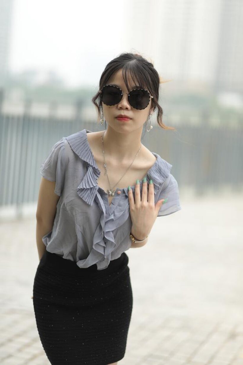 Asian teen teases in non-nude bridge poses wearing shades (shot 1)