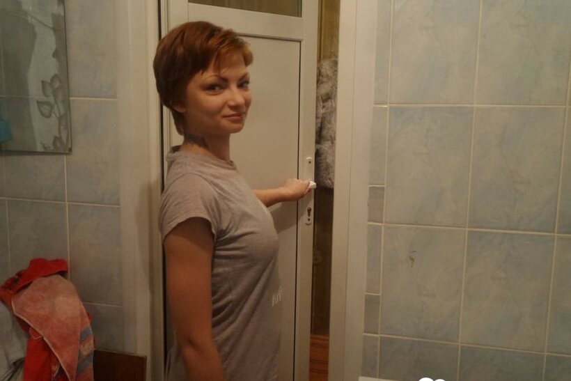 Photo 21 — Stripping down to stockings, this short-haired amateur rubs her pussy